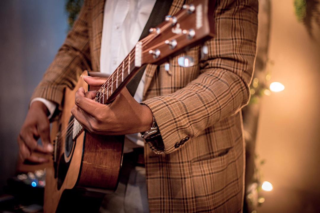 Sagarias Tsam playing an acoustic guitar in Namibia