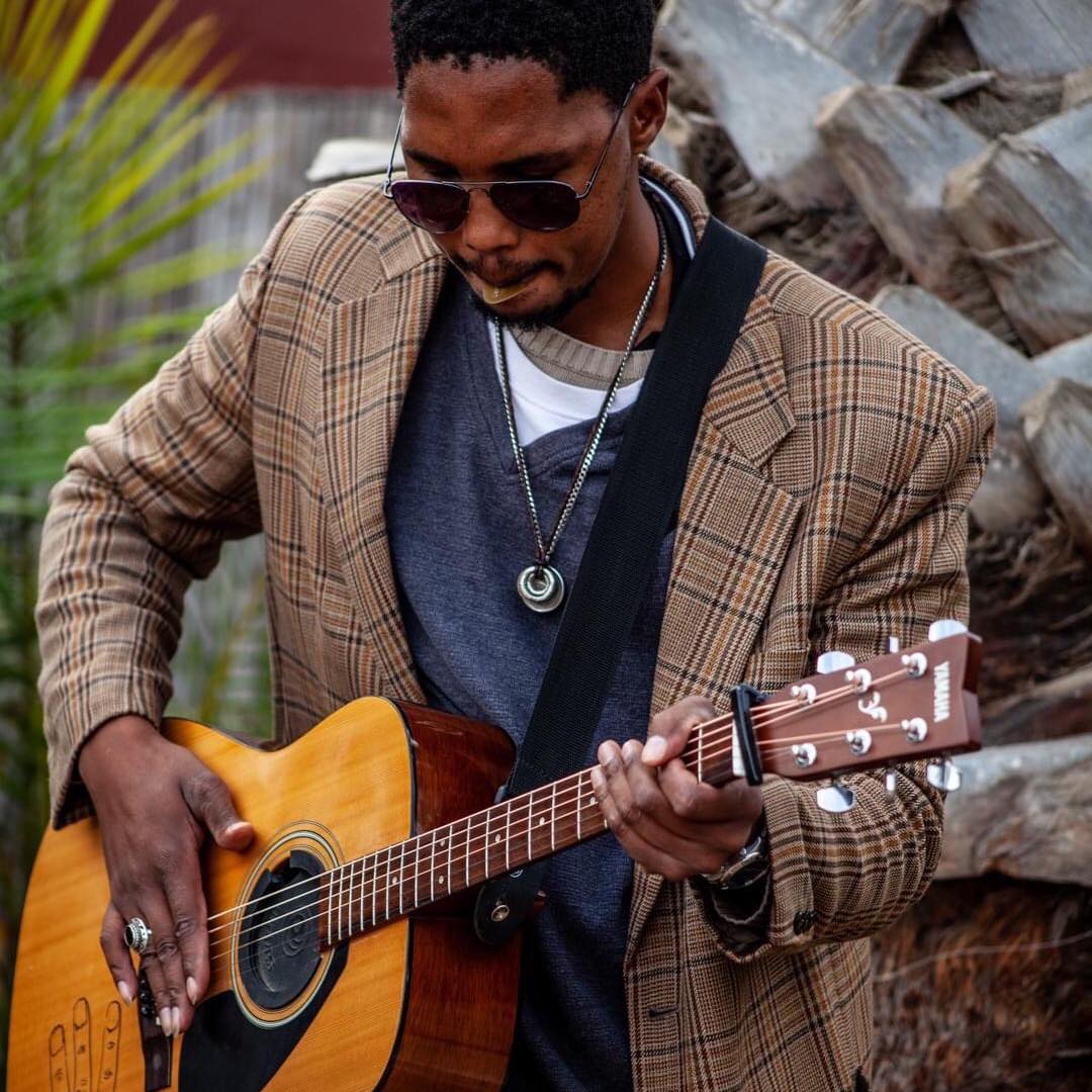 Sagarias Tsam performing a standing guitar solo
